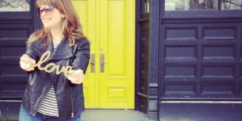 rochelle bergstrom holding a sign that says love