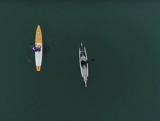 marguerite martin and dean burke paddle boarding in winter a