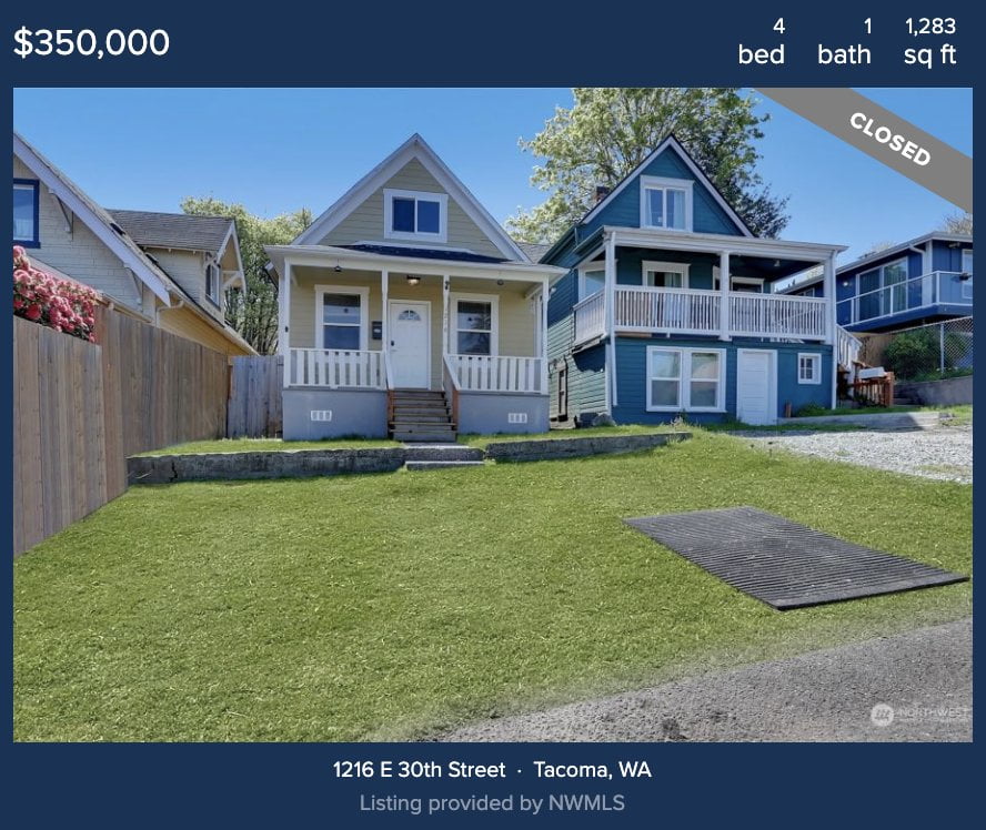 Two homes in the mckinley hill neighborhood of tacoma- one beige and one blue, both with white trim face the street. 