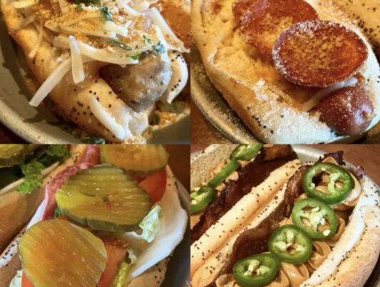 A photo of four different hot dogs with all the fixins from The Red Hot